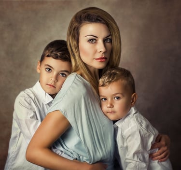 a mother embracing her two young boys in a family photo session