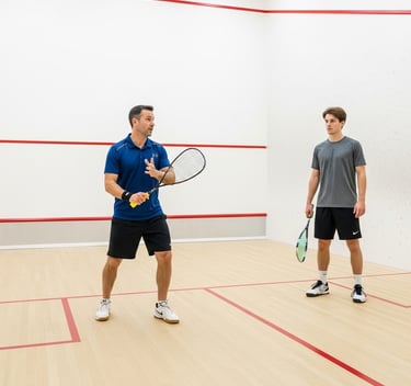 Squash coach and a client playing squash on a court