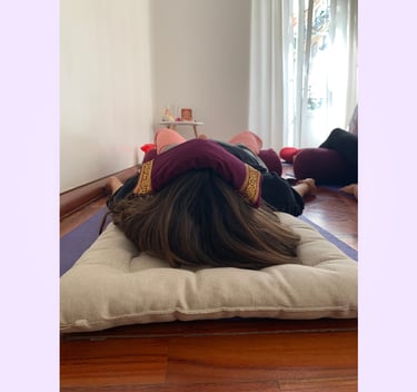 A workshop participant with an eye pillow over their eyes during a guided meditation in Lisbon.