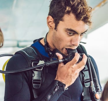 a man in a scuba suit prepair for dive