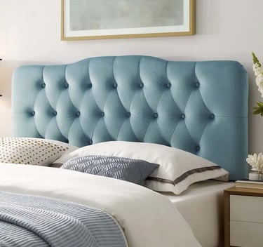 Tufted light blue velvet headboard with diamond stitching on a modern bed.
