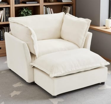 Comfortable white fabric armchair with matching ottoman in a modern living room setting.