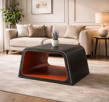 Modern black leather coffee table with orange interior in a cozy, minimalist living room setting.