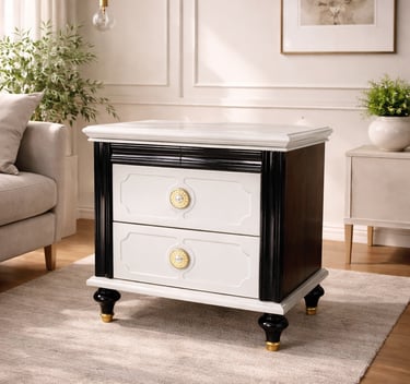 Elegant black and white nightstand with gold hardware in a modern living room setting.