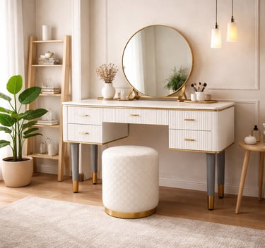 Modern white vanity desk with a round gold mirror, fluted drawers, and a matching tufted stool in a bright bedroom.