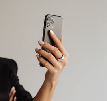 Person holding a smartphone while recording content for social media.