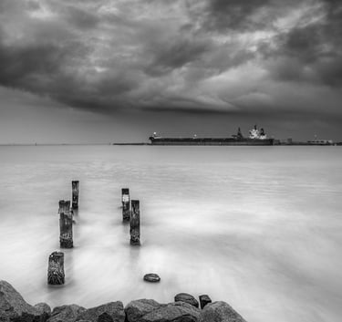 grey scale picture of port with ship loading