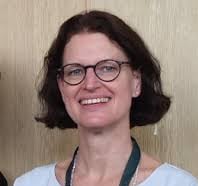 a woman in glasses and a white shirt