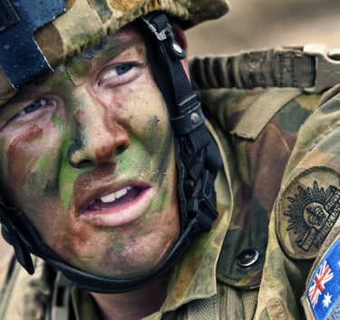 Close up of an Australian soldier in full camouflage uniform and face paint