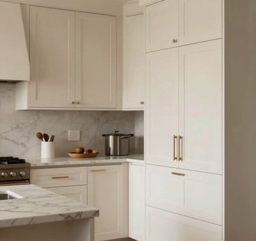A professional architectural photograph of a modern, light-filled kitchen in Portland, Oregon, featuring bespoke cream-colored cabinets and clean-lined finish carpentry, North American / Pacific Northwest US.
