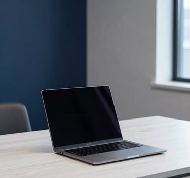 A minimalist, high-tech workspace in a North American corporate office featuring a sleek laptop on a desk made of white oak. The lighting is soft and natural, with deep navy and soft gray-blue accents in the background decor, creating a professional and intelligent atmosphere.