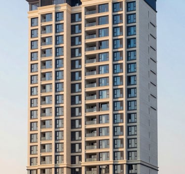 A high-definition photograph of a luxury high-rise residential complex in Noida, India, during the golden hour, showing clean architectural lines and elegant dark blue and off-white accents.