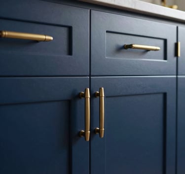 A close-up of high-end kitchen cabinets in a North American / Southern California home, featuring a flawless deep navy blue fine finish and muted gold hardware.