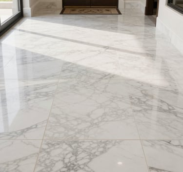 A high-end, professionally installed marble tile floor in a spacious, sunlit North American / US home entrance, showing premium craftsmanship and clean lines.