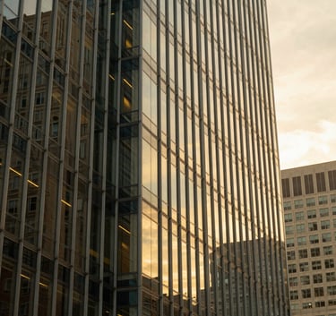 The exterior of a contemporary, high-tech glass building in a prominent US business district during the golden hour, reflecting a warm yellow sky and symbolizing innovation and professional growth.