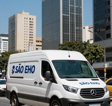 A clean white delivery van with professional markings driving through an upscale business district in São Paulo, clear blue sky, dynamic street-level photography.