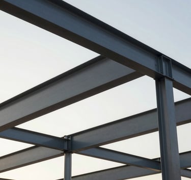 Professional photography of a construction project in Brazil featuring structural steel beams against a bright morning sky, clean and modern composition.