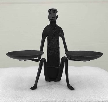 "Handcrafted tribal iron art-seated man holding oil lamps-front view-for international trade"