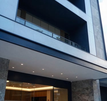 A detailed shot of a sleek building lobby entrance in Brazil, featuring high ceilings and modern architectural details in navy and light blue tones.