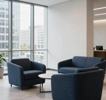 Photography of a clean, minimalist corporate lobby in a North American / US city office, featuring deep navy and slate blue furniture with bright natural lighting.