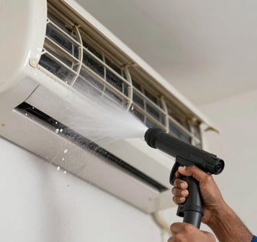 A close-up photograph of a South Asian service expert performing jet pressure cleaning on an indoor AC unit, water droplets and clean fins visible, professional and efficient atmosphere.