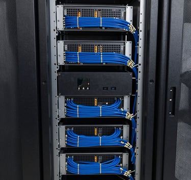View of a modern cloud server rack with organized blue wiring and glowing led indicators, clean technological setup.