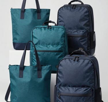 A high-quality studio shot of various customized tote bags and backpacks in Sea Teal and Dark Charcoal Blue colors, arranged neatly on a Soft Ice White background.