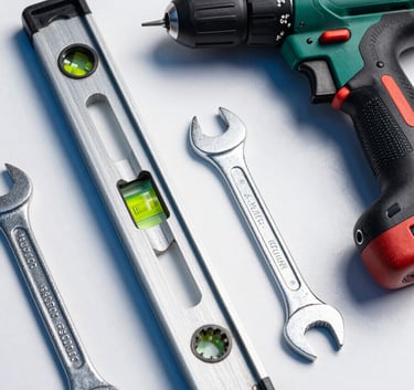 A high-quality flat lay of professional tools including a spirit level, a wrench, and a drill, arranged neatly on a white surface with electric blue highlights, photography, French / Southern France style.