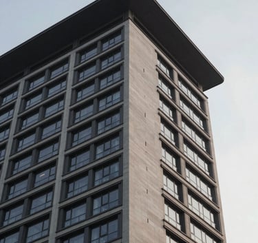 A low-angle shot of a modern high-rise building against a soft grey sky, highlighting the clean lines of the roof and external walls, symbolizing durable protection and professional structural solutions.
