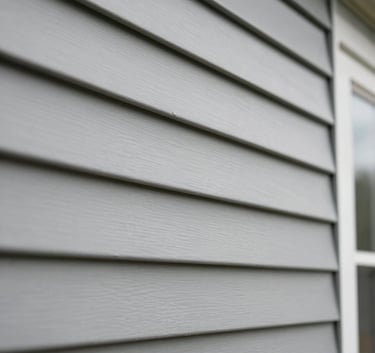 Detailed shot of high-quality vinyl siding installation on a residential building in the US, showing the clean lines and professional craftsmanship under soft natural light.