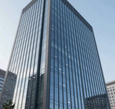 Wide-angle shot of a modern glass office building facade under a clear sky, symbolizing large-scale commercial cleaning excellence, with tones of #1A202C and #A8D0DB.