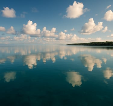 Panoramic view of the New Caledonian lagoon with soft white clouds reflecting in the calm, deep teal water, morning light, South Pacific serenity, wide angle.