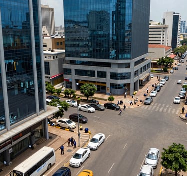 Professional high-angle shot of a busy commercial district in Lagos, Nigeria, featuring modern vehicles and glass office buildings. The lighting is bright and crisp, with deep blue and light gray tones throughout.