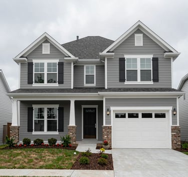 The exterior of a clean, modern single-family home in Durham, NC, under a Light Mist colored sky. The North American / US (Southeast) architecture is highlighted by professional landscaping and an organized, welcoming entrance.