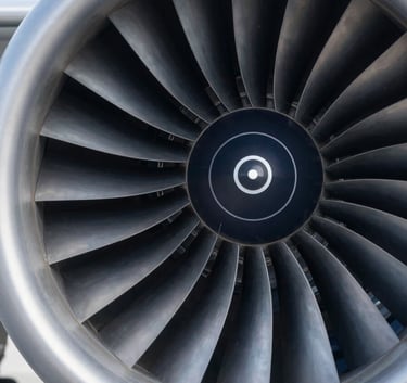A close-up, high-detail shot of a modern jet engine's turbine blades. The lighting is cool and sophisticated, highlighting the metallic textures and precision engineering. The color palette includes deep navy shadows (#0A1C2B) and bright metallic highlights (#F2F4F7), reflecting an authoritative and innovative mood.