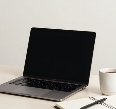 A professional workspace with a laptop, notebook, and a coffee cup on a light desk, North American / US office setting, clean and efficient mood, Off-white background.