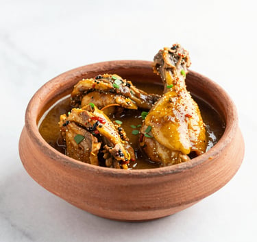 A bright, high-key close-up of a garnished Pakistani chicken handi in a traditional clay pot on a clean white marble surface, soft natural daylight.