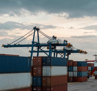 A bustling South American cargo port at dawn, showing large shipping containers and a professional logistics atmosphere with a sky reflecting soft dark teal and off-white hues.