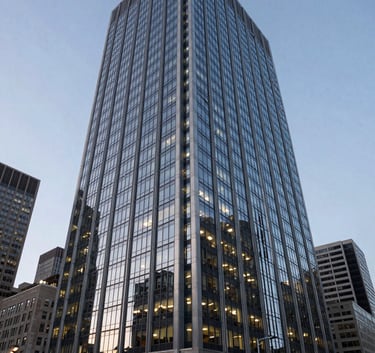 A sharp, wide-angle shot of a modern glass-and-steel office building in a major North American city at dusk, representing high-level corporate infrastructure and success.