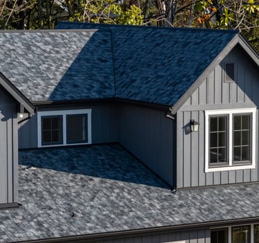 A modern residential home in New Jersey with a sleek navy blue and charcoal asphalt shingle roof, clean professional photography, North American / US.