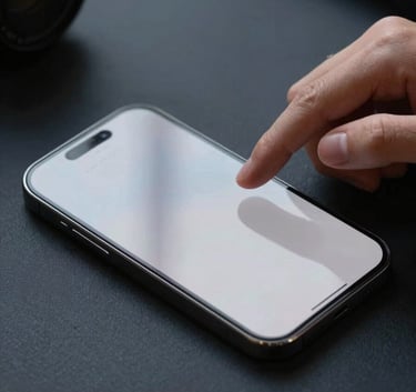 A close-up of a designer's hands interacting with a high-end smartphone on a Dark Navy desk, with soft Pale Cloud Grey reflections on the screen.