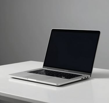 A sleek, minimalist shot of a silver high-performance laptop on a polished white desk in a professional North American / US studio. Soft, neutral lighting emphasizes the sophisticated design.