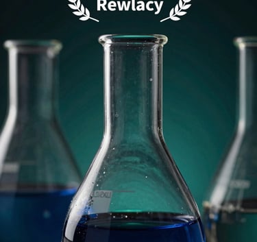 An artistic close-up of high-end laboratory glassware, specifically a round-bottom flask, with soft lighting transitions from deep navy blue to dark forest teal in the background.