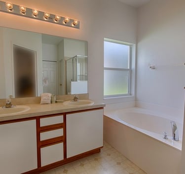 a bathroom with a tub and a large mirror