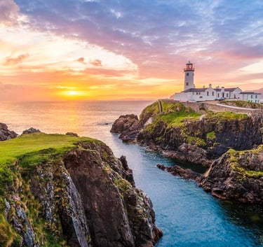 a lighthouse at sunset with a lighthouse in the background