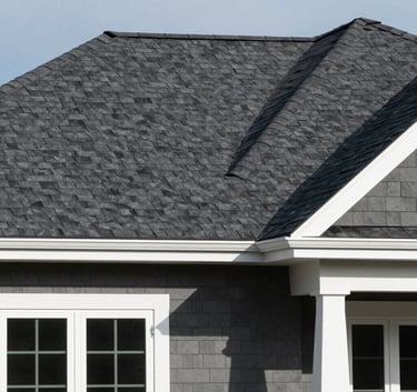 The exterior of a modern North American suburban house showcasing a newly installed dark charcoal grey shingle roof and crisp white window frames, daytime lighting.