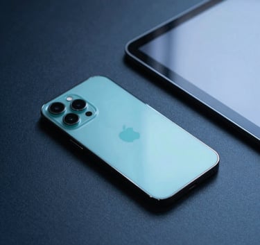 A sleek smartphone and a digital tablet resting on a dark blue designer desk. The composition is minimalist and innovative, with cool cyan light reflecting off the screen surfaces. International / Global tech style.