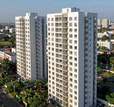 A high-angle view of a clean, contemporary residential apartment complex in an Indian city, with lush green surroundings and clear blue sky, architectural photography.
