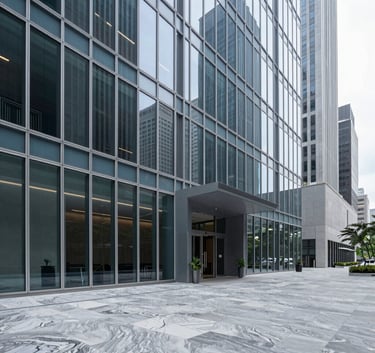 A wide-angle professional photograph of a sophisticated glass-walled office lobby in a North American financial district. The scene is minimalist with sharp lines, polished marble floors, and a palette of steel blue and light grey. The lighting is crisp and authoritative.