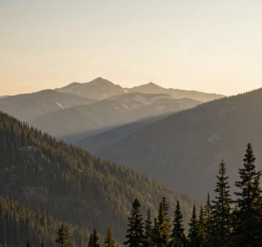 A wide-angle, peaceful shot of the Cascade Mountains near Redmond, Oregon during sunrise, with soft warm alabaster light and pine green forests in a North American / US natural environment.